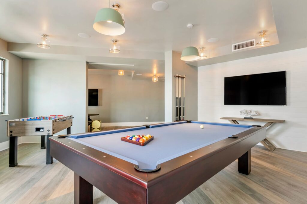 Clubhouse game room with TV, Billiards, and foosball