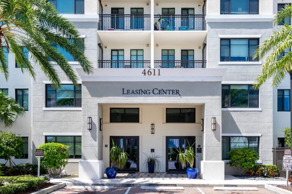 Leasing office exterior with palm trees