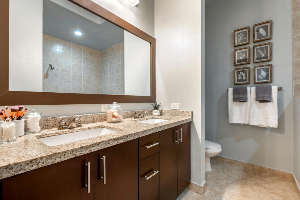 Bathroom with double vanity and granite countertops