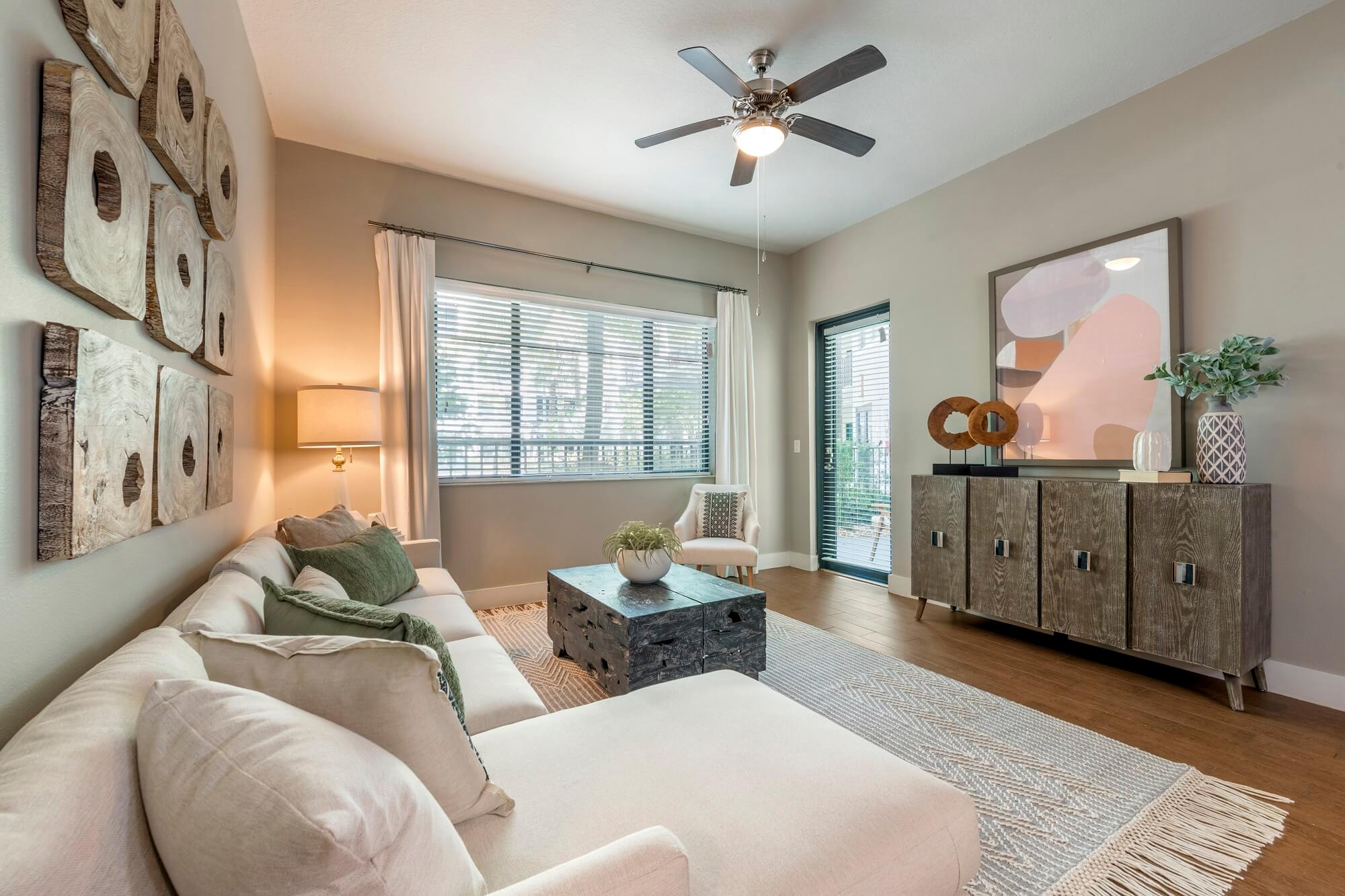 Model living room with large windows and patio door