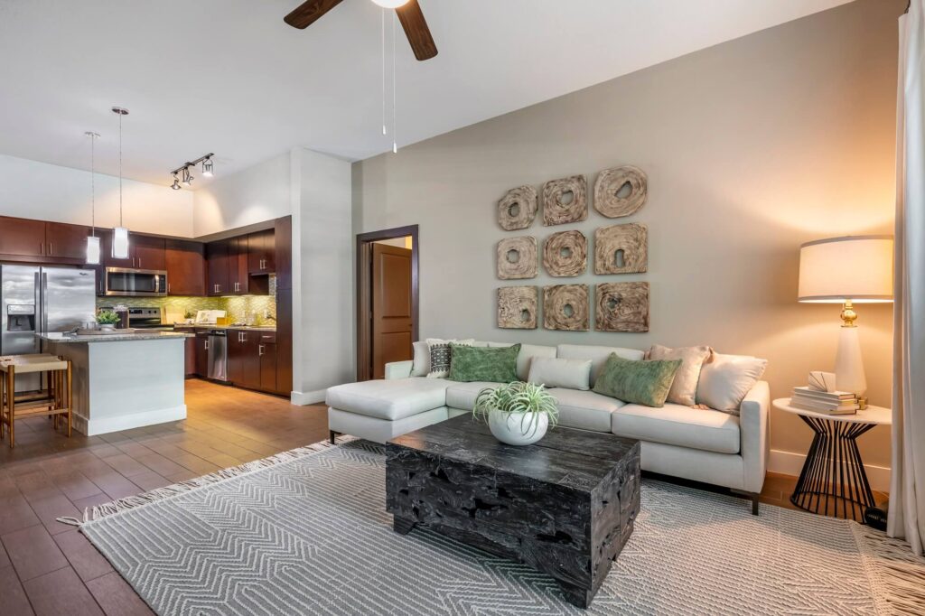 Model living room and open kitchen with island seating