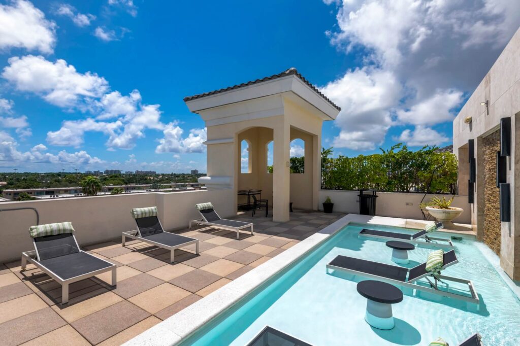 Rooftop pool tanning ledge with covered deck seating