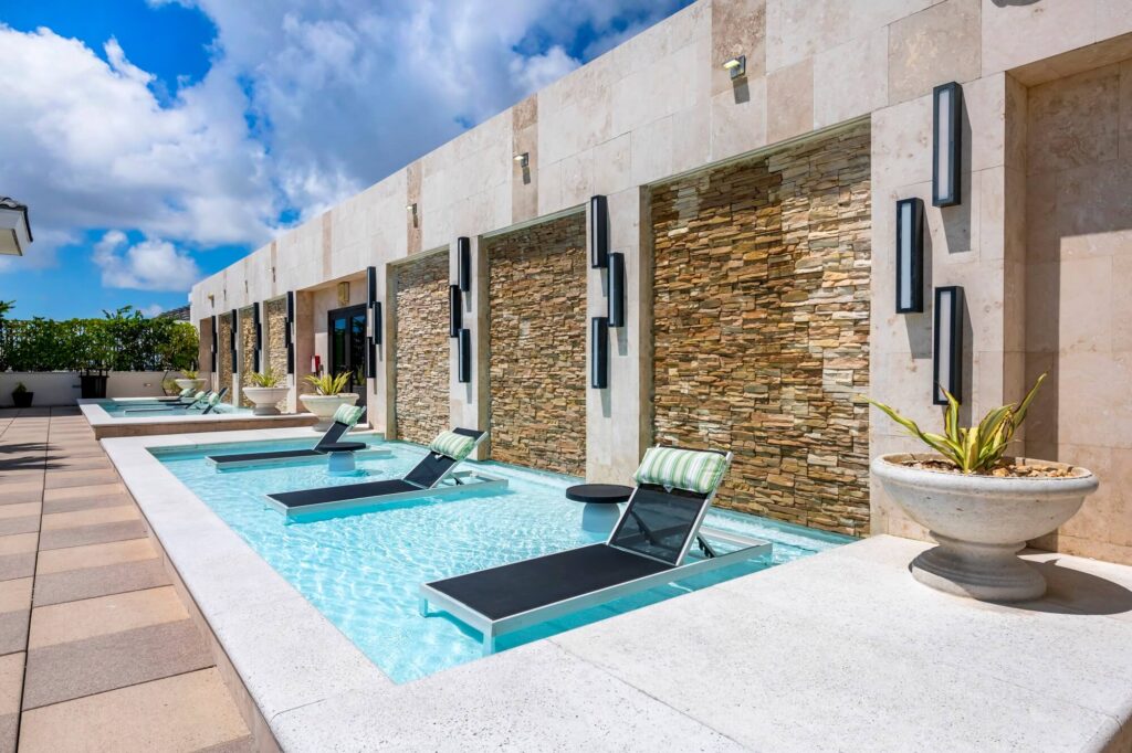 rooftop pool tanning ledge with reclining deck chairs