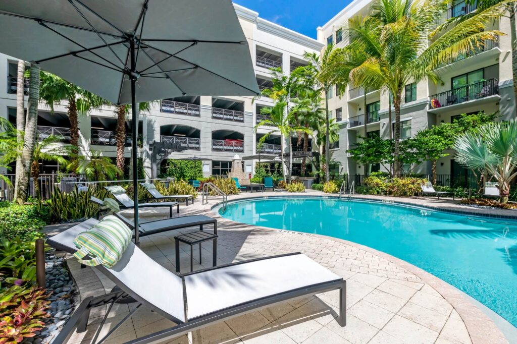 Pool courtyard with large trees and covered seating